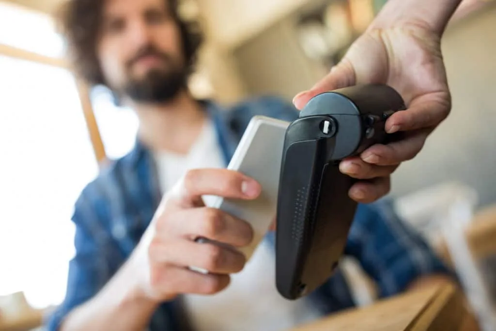man paying with nfc technology mobile phone 1024x683
